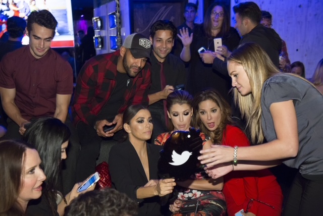 Alicia coaching talent on social content at a live event, representing the origin of the social embed role